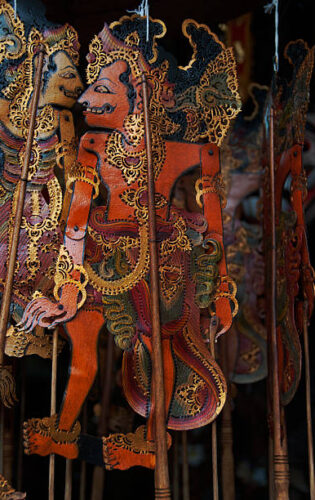 Intricately cut traditional Balinese decorative ceremonial figures souvenirs, made of leather, for sale in Ubud market, Ubud, Bali, Indonesia.