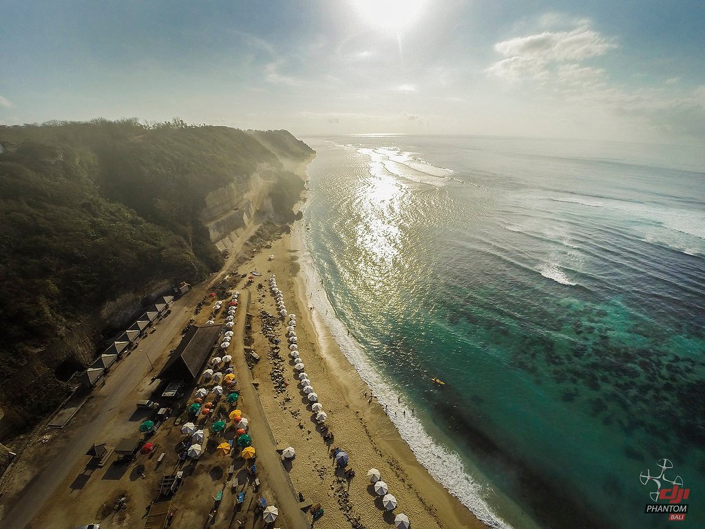 White sand beach between cliffs in Bali