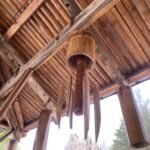Bamboo wind chimes hanging under a bamboo roof