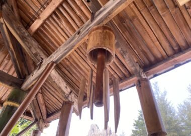 Bamboo wind chimes hanging under a bamboo roof