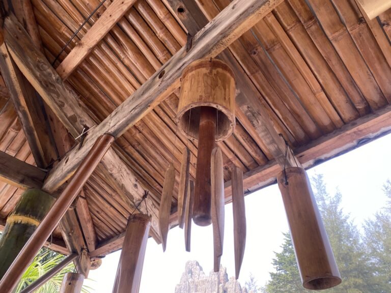 Bamboo wind chimes hanging under a bamboo roof